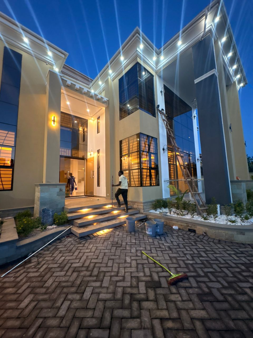 Exterior cleaning of a luxury villa at dusk